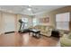 Living room with hardwood floors, sofa, and treadmill at 7182 Hood River Ave, Las Vegas, NV 89179