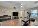 Living room with hardwood floors, TV, and treadmill at 7182 Hood River Ave, Las Vegas, NV 89179