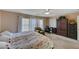 Main bedroom featuring a king bed, sitting area, and large windows at 7182 Hood River Ave, Las Vegas, NV 89179