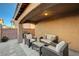 Covered patio features seating and a built-in grill at 7182 Hood River Ave, Las Vegas, NV 89179