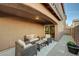 Outdoor patio with seating area and adjacent yard at 7182 Hood River Ave, Las Vegas, NV 89179