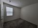 Simple bedroom with gray carpet, window with blinds, and neutral walls at 7672 Lush Oasis Ave, Las Vegas, NV 89113