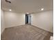 Spacious loft area with gray carpet and access to bedrooms at 7672 Lush Oasis Ave, Las Vegas, NV 89113