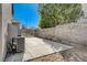 Backyard with concrete patio, block wall, and air conditioning unit at 7900 Holly Knoll Ave, Las Vegas, NV 89129