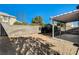 Backyard view showcasing a covered patio and a block wall at 7900 Holly Knoll Ave, Las Vegas, NV 89129