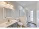 Modern bathroom with gray vanity, white toilet, and glass shower at 7900 Holly Knoll Ave, Las Vegas, NV 89129