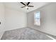 Bright bedroom with large window, ceiling fan and grey carpet at 7900 Holly Knoll Ave, Las Vegas, NV 89129