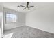 A sunlit bedroom with a modern ceiling fan and plush gray carpeting at 7900 Holly Knoll Ave, Las Vegas, NV 89129