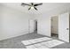 Bedroom featuring modern carpet, ceiling fan, and dual closets for extra storage at 7900 Holly Knoll Ave, Las Vegas, NV 89129