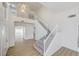 Two-story entryway with gray-carpeted staircase and wood-look floors at 7900 Holly Knoll Ave, Las Vegas, NV 89129