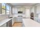 Modern kitchen with gray cabinets and a large island at 7900 Holly Knoll Ave, Las Vegas, NV 89129