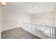 Well-lit upstairs landing featuring modern pendant lighting and a staircase with white railing at 7900 Holly Knoll Ave, Las Vegas, NV 89129