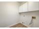 Bright laundry room with white cabinets and modern washer/dryer hookups at 7900 Holly Knoll Ave, Las Vegas, NV 89129