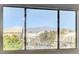 The view from the window features trees and the rooftops of nearby homes at 7900 Holly Knoll Ave, Las Vegas, NV 89129