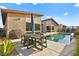 Inviting backyard with a sparkling pool, dining table, and grill at 803 Bolide St, Las Vegas, NV 89138