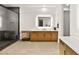 Modern bathroom with a large mirror, double vanity with wood cabinets, and a walk-in shower at 803 Bolide St, Las Vegas, NV 89138