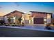 Modern home with stone and wood siding; attached garage and landscaping at 803 Bolide St, Las Vegas, NV 89138