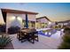 Modern pool and patio with dining area and built-in grill at 803 Bolide St, Las Vegas, NV 89138