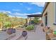 Landscaped backyard with a covered patio and cacti at 900 Mckinley View Ave, Henderson, NV 89012