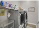 Laundry room with washer, dryer, and storage shelves at 900 Mckinley View Ave, Henderson, NV 89012