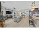 Open living room showcasing hardwood floors, a cozy seating area, and a large TV at 900 Mckinley View Ave, Henderson, NV 89012