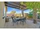 Relaxing patio features a dining set under pergola at 900 Mckinley View Ave, Henderson, NV 89012