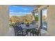 Covered patio with a table, chairs, and view of the backyard at 900 Mckinley View Ave, Henderson, NV 89012