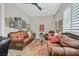 Cozy sitting area with leather sofas, a coffee table, and gallery wall at 900 Mckinley View Ave, Henderson, NV 89012