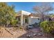 Relaxing backyard with covered patio, fire pit, and rock landscaping at 968 Mill Run Creek Ave, Henderson, NV 89002