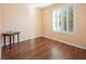 Bedroom with wood floors, window, and side table at 968 Mill Run Creek Ave, Henderson, NV 89002