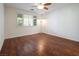 Bright bedroom with wood-look floors and ceiling fan at 968 Mill Run Creek Ave, Henderson, NV 89002