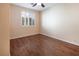 Spacious bedroom featuring wood floors and a window with shutters at 968 Mill Run Creek Ave, Henderson, NV 89002