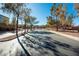 Gated community entrance with paved road and mature trees at 968 Mill Run Creek Ave, Henderson, NV 89002