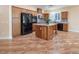 Spacious kitchen boasts dark wood cabinets and an island at 968 Mill Run Creek Ave, Henderson, NV 89002