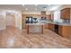 Bright kitchen with island, stainless steel appliances, and tile floor at 968 Mill Run Creek Ave, Henderson, NV 89002