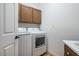 Laundry room with washer, dryer, and upper cabinets at 968 Mill Run Creek Ave, Henderson, NV 89002