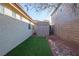 Landscaped side yard with artificial turf and storage shed at 968 Mill Run Creek Ave, Henderson, NV 89002