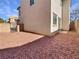 Side backyard with gravel and a partial view of the home's exterior at 10809 Wrigley Field Ave, Las Vegas, NV 89166