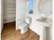 Bright bathroom with a pedestal sink, toilet, and built-in shelves for storage at 10809 Wrigley Field Ave, Las Vegas, NV 89166