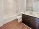 Bright bathroom with combination shower and tub, and dark wood vanity at 10809 Wrigley Field Ave, Las Vegas, NV 89166