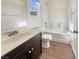 Bright bathroom featuring a vanity with a dark wood cabinet and a shower-tub combo at 10809 Wrigley Field Ave, Las Vegas, NV 89166