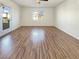 Spacious bedroom with ceiling fan, wood-look floors, and natural light at 10809 Wrigley Field Ave, Las Vegas, NV 89166