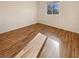 Clean, empty bedroom with neutral walls, hardwood flooring, and a bright window for natural light at 10809 Wrigley Field Ave, Las Vegas, NV 89166