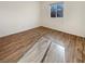 Bedroom with wood-look flooring, a window, and neutral wall color at 10809 Wrigley Field Ave, Las Vegas, NV 89166