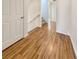 Hallway with wood-look flooring, leading to stairs and other rooms at 10809 Wrigley Field Ave, Las Vegas, NV 89166