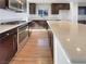Open kitchen featuring stainless steel appliances, dark cabinetry, bright countertops, and hardwood flooring at 10809 Wrigley Field Ave, Las Vegas, NV 89166