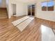 Open living room area with wood-look floors, stairs, and sliding glass door at 10809 Wrigley Field Ave, Las Vegas, NV 89166
