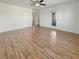 Large open concept living room with modern ceiling fan and wood-look flooring at 10809 Wrigley Field Ave, Las Vegas, NV 89166