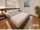 Comfortable staged main bedroom with plush carpet, a large window, neutral walls, and a stylish decor at 10809 Wrigley Field Ave, Las Vegas, NV 89166