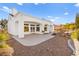 Private backyard with a covered patio, desert landscaping, and plenty of room for outdoor activities at 10920 Grand Haven Ave, Las Vegas, NV 89134